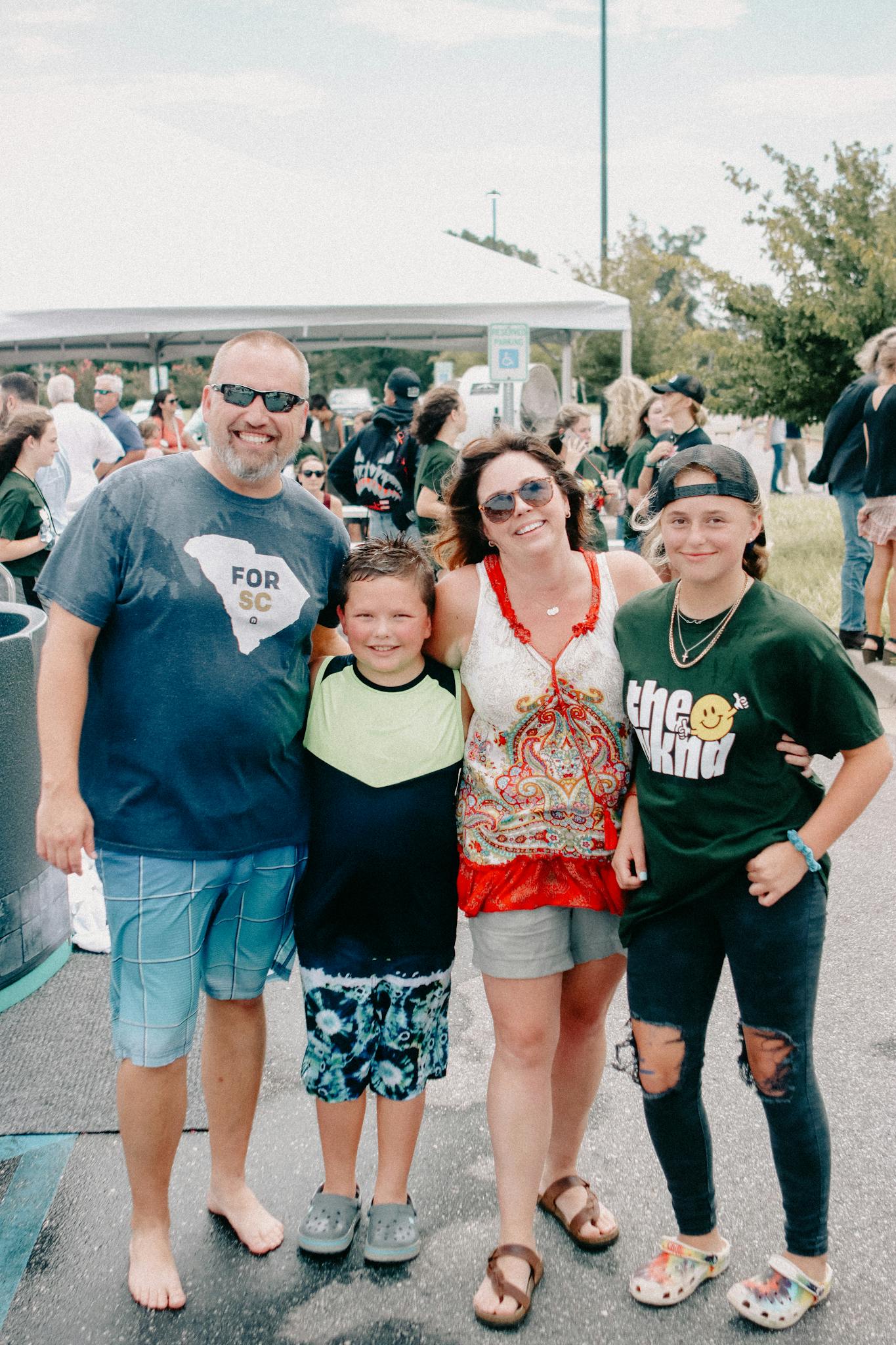 Family poses at an outdoor baptism event in Clemson, South Carolina.